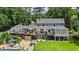 Aerial view of a large home with multiple decks, a pool, and beautifully landscaped backyard at 555 Valley Hall Dr, Atlanta, GA 30350