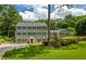Charming traditional home with a symmetrical facade, lush lawn, and a welcoming red front door at 555 Valley Hall Dr, Atlanta, GA 30350