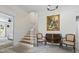 Beautiful foyer with wood stairs, marble floors, painting, and bench seating at 555 Valley Hall Dr, Atlanta, GA 30350
