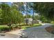 Charming two-story home with gray siding and a stone accent, surrounded by lush greenery and a long driveway at 555 Valley Hall Dr, Atlanta, GA 30350