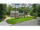 Charming two-story home with gray siding and stone accents, surrounded by lush greenery and a circular driveway at 555 Valley Hall Dr, Atlanta, GA 30350