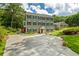 Beautiful two-story home with gray siding and stone accents featuring a long driveway and lush greenery at 555 Valley Hall Dr, Atlanta, GA 30350