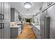 Spacious kitchen with gray cabinets, stainless steel appliances, marble countertops, and herringbone floors at 555 Valley Hall Dr, Atlanta, GA 30350