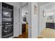 Laundry closet with a modern stacked washer and dryer near the hall bathroom at 555 Valley Hall Dr, Atlanta, GA 30350