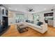 Cozy living room featuring a white couch, hardwood floors, and a stylish bar area at 555 Valley Hall Dr, Atlanta, GA 30350