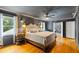 Modern main bedroom boasts a ceiling fan, hardwood floors, and ensuite bathroom at 555 Valley Hall Dr, Atlanta, GA 30350