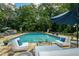Inviting pool area with comfortable lounge seating and umbrella, great for summer relaxation and entertaining at 555 Valley Hall Dr, Atlanta, GA 30350
