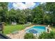 Beautiful backyard pool area complete with a pool slide, lounge chairs, and meticulous landscaping at 555 Valley Hall Dr, Atlanta, GA 30350