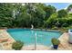 Relaxing pool with stone surround and fence overlooking the beautiful wooded property at 555 Valley Hall Dr, Atlanta, GA 30350