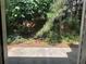 The backyard is green and lush, covered in vegetation and trees at 76 Daisy Meadow Trl, Lawrenceville, GA 30044