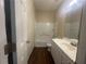 Bright bathroom features a tub-shower combo, white vanity, and a large mirror at 76 Daisy Meadow Trl, Lawrenceville, GA 30044