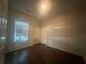 Bedroom features a window letting in natural light and vinyl wood floors at 76 Daisy Meadow Trl, Lawrenceville, GA 30044
