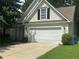 Charming home with a two-car garage and mature landscaping at 76 Daisy Meadow Trl, Lawrenceville, GA 30044