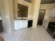 Kitchen with white cabinets, black appliances and tile flooring at 76 Daisy Meadow Trl, Lawrenceville, GA 30044