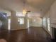 Open-concept living room features hardwood floors, ceiling fan, fireplace, and natural light at 76 Daisy Meadow Trl, Lawrenceville, GA 30044
