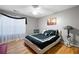 Comfortable bedroom with a ceiling fan, hardwood floors, large window and black and white accents at 1227 Castle Point Sw Ct, Conyers, GA 30094