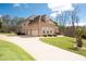 Brick home with a long driveway, attached garage, and well-maintained lawn and landscaping at 1227 Castle Point Sw Ct, Conyers, GA 30094