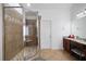 Tiled shower with glass enclosure and a bench, alongside granite countertops and vanity at 1227 Castle Point Sw Ct, Conyers, GA 30094