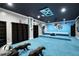 Theater room with plush blue carpeting, custom stage, projector, and Panthers decor at 1227 Castle Point Sw Ct, Conyers, GA 30094