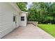 View of the home's back deck and exterior; door leads outside to grass and large trees for outdoor enjoyment at 240 Melrose Ave, Decatur, GA 30030
