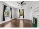 Bright bedroom with hardwood floors, fireplace, and windows with dark curtains at 240 Melrose Ave, Decatur, GA 30030