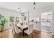 Open dining room with wood floors, modern lighting, and a view to the kitchen at 240 Melrose Ave, Decatur, GA 30030