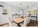 Dining room with light wood table, neutral chairs, and pass through to kitchen at 240 Melrose Ave, Decatur, GA 30030