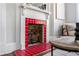 Close-up of red tile fireplace with white mantle and hardwood floors at 240 Melrose Ave, Decatur, GA 30030