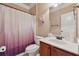 Cozy bathroom featuring a vanity with a white sink, a toilet, and a tub with a decorative pink shower curtain at 2629 Muskeg Sw Ct, Atlanta, GA 30331