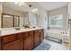 Bathroom features a double sink vanity, a soaking tub, a separate shower, and a large framed mirror at 2629 Muskeg Sw Ct, Atlanta, GA 30331