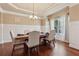 Elegant dining room with hardwood floors, wainscoting, and a chandelier at 2629 Muskeg Sw Ct, Atlanta, GA 30331