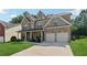 Charming two-story brick home with a well-manicured lawn and a two car garage at 2629 Muskeg Sw Ct, Atlanta, GA 30331