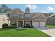 Charming two-story brick home with a well-manicured lawn and inviting front porch at 2629 Muskeg Sw Ct, Atlanta, GA 30331