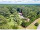 Aerial view of home showcasing lush greenery, pool area, and private, secluded setting at 7234 Post Rd, Winston, GA 30187