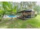 Charming backyard featuring pool, screened-in porch, dining area, and a beautiful, lush green yard at 7234 Post Rd, Winston, GA 30187