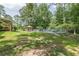 Backyard featuring fenced in-ground pool, lush lawn, and covered porch at 7234 Post Rd, Winston, GA 30187