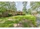 Well-manicured backyard with a brick home, covered deck and cabana near the in-ground pool at 7234 Post Rd, Winston, GA 30187