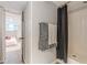 Bathroom featuring a shower with a grey shower curtain and a black and white hand towel at 7234 Post Rd, Winston, GA 30187