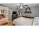 Bedroom featuring hardwood floors, a ceiling fan, and a decorative wall mirror at 7234 Post Rd, Winston, GA 30187