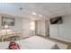 Well-lit basement bedroom with decorative ceiling, desk, and doorway that offers a calming and inviting space at 7234 Post Rd, Winston, GA 30187