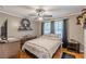 Comfortable bedroom featuring hardwood floors, ceiling fan, and ample natural light at 7234 Post Rd, Winston, GA 30187