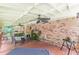 Covered brick patio with ceiling fans, dining table, plants and patio furniture at 7234 Post Rd, Winston, GA 30187