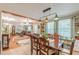 Open floor plan with dining area featuring hardwood floors, decorative ceiling, and a table set for six at 7234 Post Rd, Winston, GA 30187