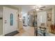 Inviting entryway with glass door and a view into the kitchen with stainless steel appliances at 7234 Post Rd, Winston, GA 30187