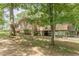 Two-story home boasts a covered carport and is adorned with brick accents and mature trees at 7234 Post Rd, Winston, GA 30187