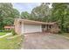 Exterior view of a brick home with a white garage door and front porch at 7234 Post Rd, Winston, GA 30187