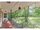 Charming front porch with black iron railings, Knock Knock welcome mat, and green yard at 7234 Post Rd, Winston, GA 30187