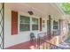 Charming front porch featuring classic iron railings and a cozy seating area at 7234 Post Rd, Winston, GA 30187