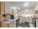 Bright kitchen featuring stainless steel appliances, granite counters and white cabinets at 7234 Post Rd, Winston, GA 30187