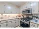 Well-equipped kitchen with stainless steel appliances, gas range, and ample counter space at 7234 Post Rd, Winston, GA 30187